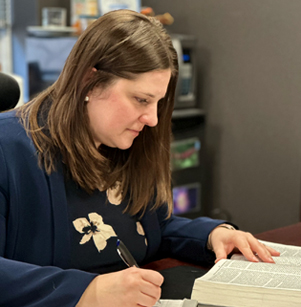 Ania Wlodek Moncrief working on legal papers at her desk